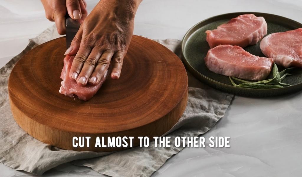 Step 2 to butterflying a pork chop - cut almost to other side Step 2 to butterflying a pork chop - cut almost to other side